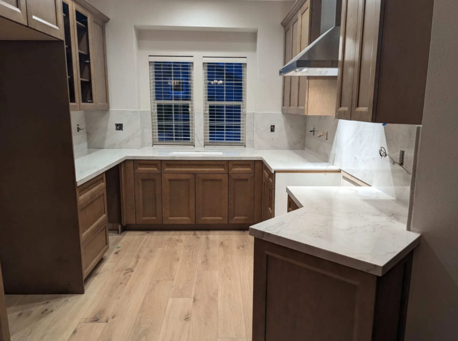 Quartz countertops in a wood-cabinet kitchen